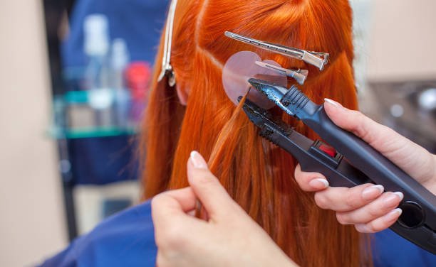 What are hair extensions and how are they applied?